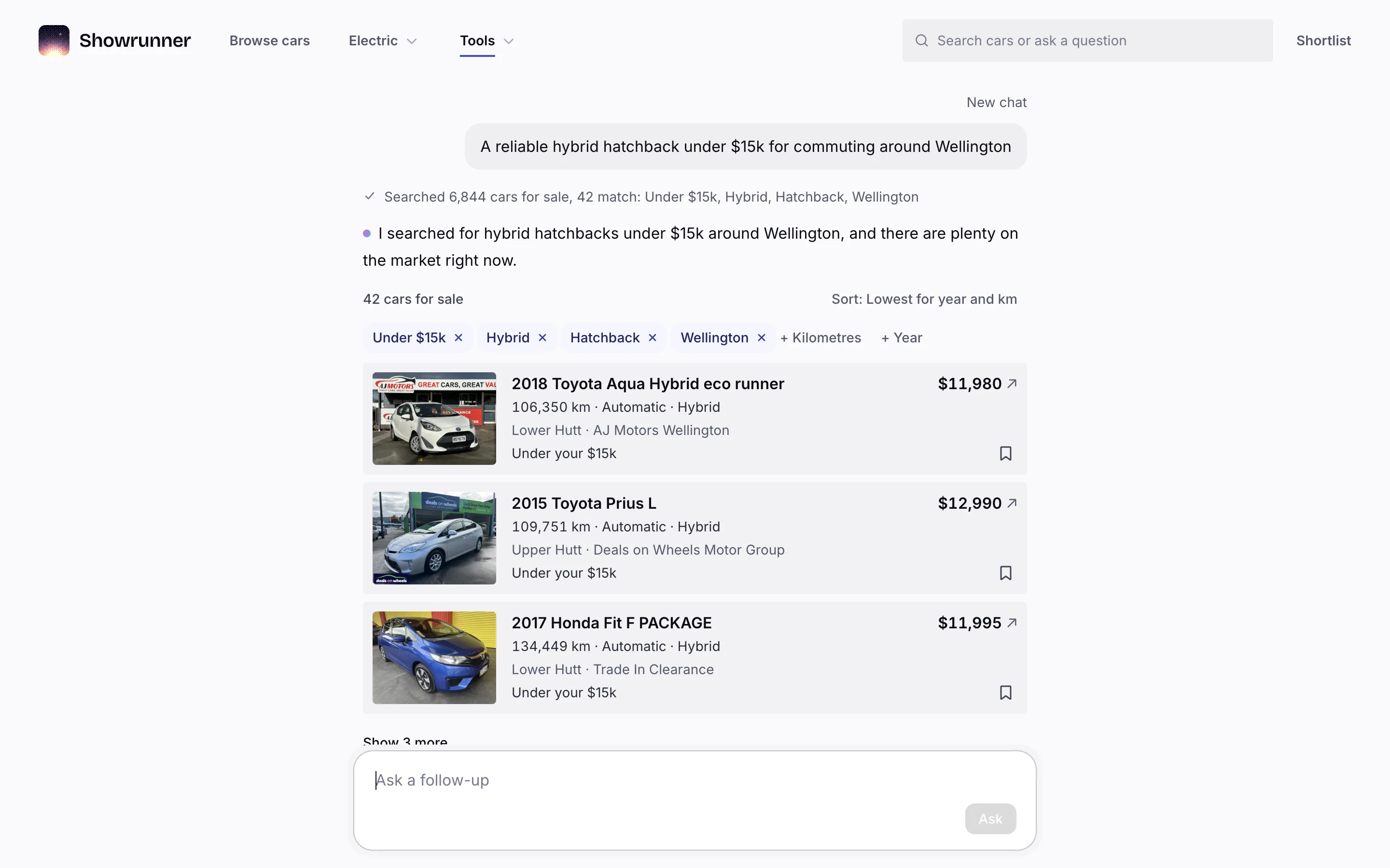 The assistant answering “A reliable hybrid hatchback under $15k for commuting around Wellington” with a search trail, a short reply, the filters as removable pills and three car cards